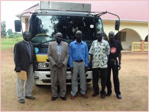 RamaDBK representatives with customers beside an exported bus